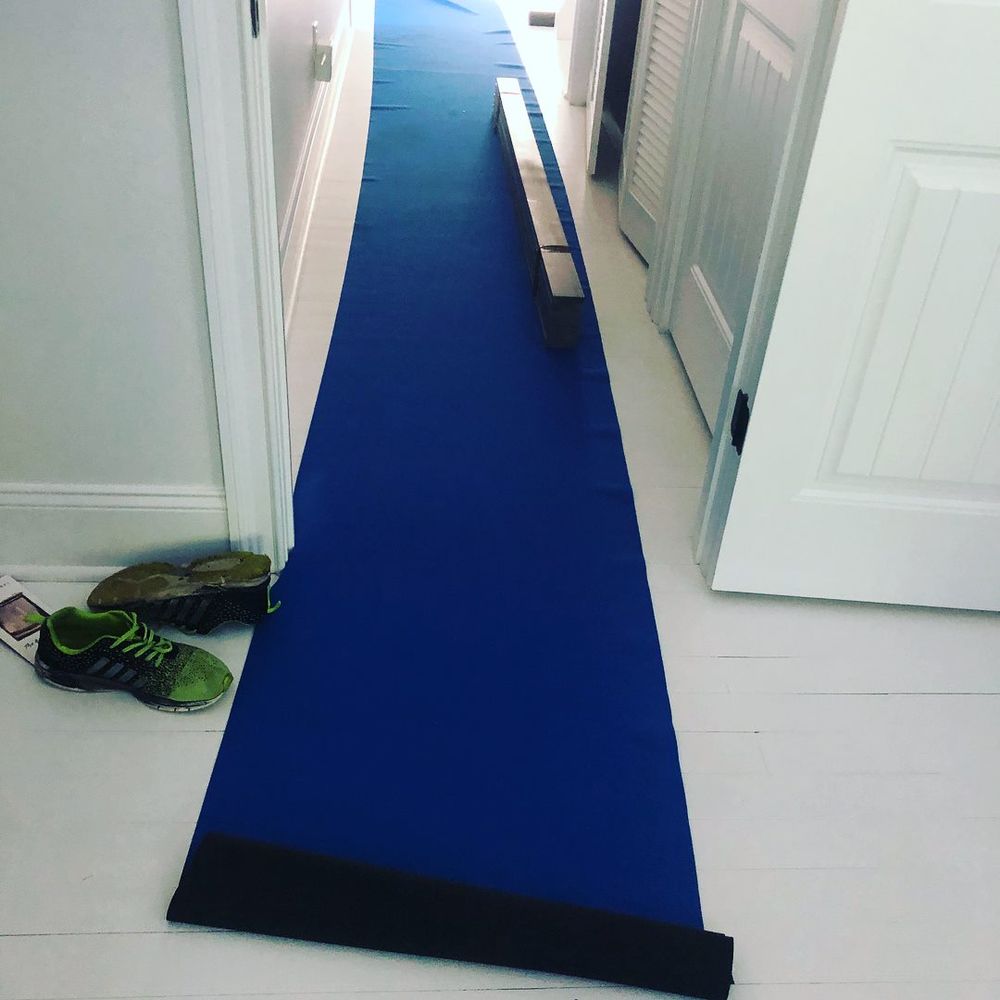 Movers laying floor protection in an SE Valley home